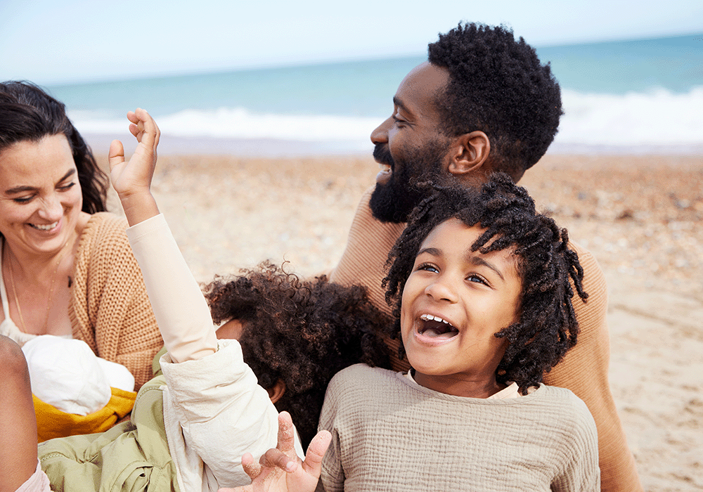 Family laughing on the beach