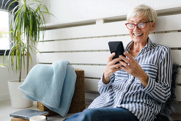 mature woman looking at her phone